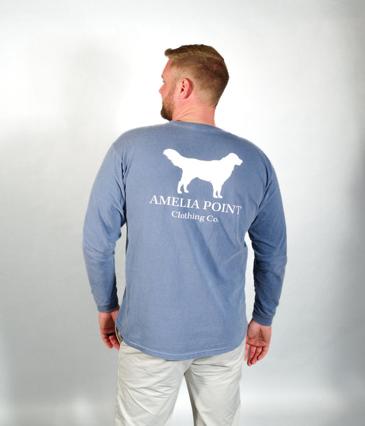 Up close image of the back side of the shirt on a male person, large golden retriever logo in white color on a blue jean color long sleeve shirt, Amelia Point Clothing Co is underneath the retriever logo